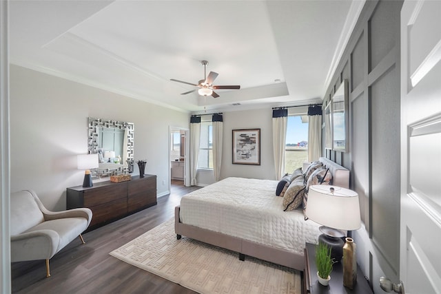 11034 Moon Light Dr, Needville, TX 77461 - bedroom featuring a raised ceiling, dark wood-style flooring, baseboards, a ceiling fan, and crown molding