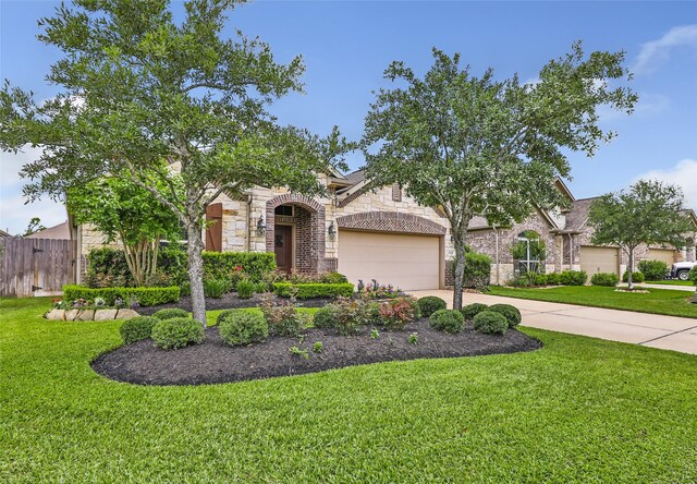 23435 Banks Mill Dr, New Caney, TX 77357 - obstructed view of property featuring stone siding, an attached garage, and concrete driveway