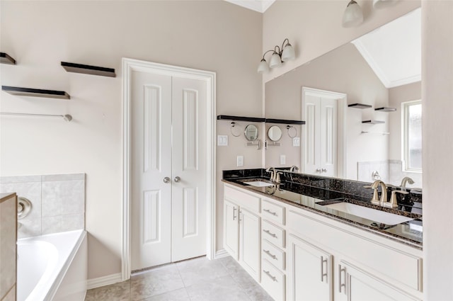 23435 Banks Mill Dr, New Caney, TX 77357 - bathroom featuring a garden tub, double vanity, tile patterned floors, baseboards, and vaulted ceiling