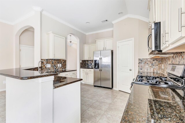 23435 Banks Mill Dr, New Caney, TX 77357 - kitchen featuring appliances with stainless steel finishes, white cabinetry, decorative backsplash, light tile patterned flooring, and ornamental molding