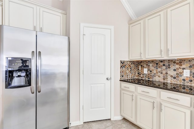 23435 Banks Mill Dr, New Caney, TX 77357 - kitchen featuring stainless steel fridge, decorative backsplash, crown molding, dark stone countertops, and light tile patterned floors