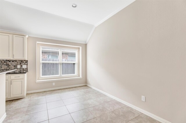 23435 Banks Mill Dr, New Caney, TX 77357 - unfurnished dining area with ornamental molding, light tile patterned floors, baseboards, and lofted ceiling