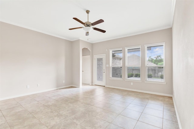 23435 Banks Mill Dr, New Caney, TX 77357 - unfurnished room with arched walkways, light tile patterned flooring, ceiling fan, baseboards, and crown molding