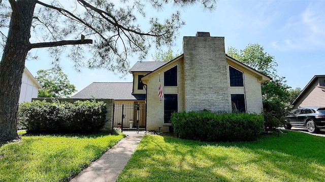 view of front of home with a chimney and a gate