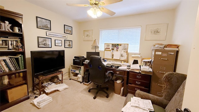 carpeted office featuring ceiling fan