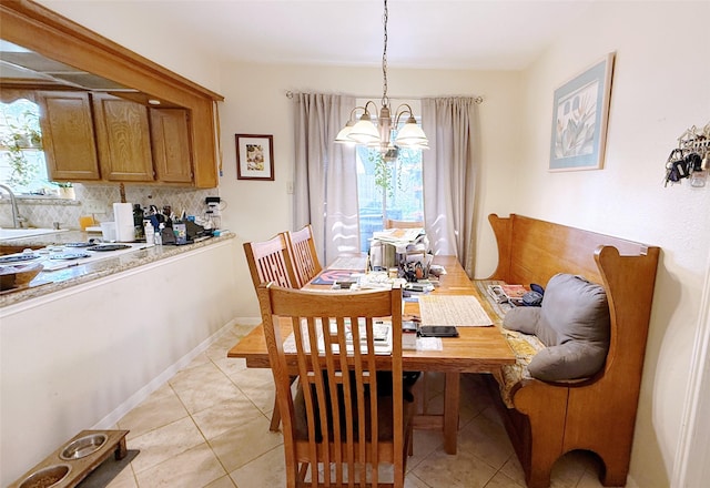 dining room featuring a chandelier and light tile patterned floors