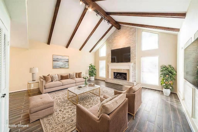 2707 Williams Grant St, Sugar Land, TX 77479 - living room with wood finish floors, beam ceiling, a fireplace with raised hearth, baseboards, and high vaulted ceiling