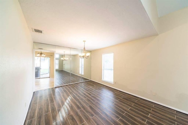 2707 Williams Grant St, Sugar Land, TX 77479 - unfurnished dining area featuring a chandelier, plenty of natural light, and wood finished floors