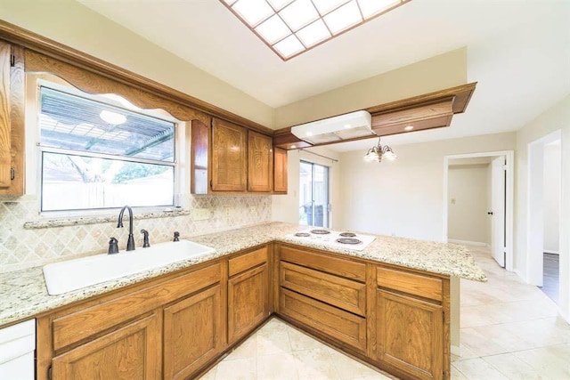 2707 Williams Grant St, Sugar Land, TX 77479 - kitchen featuring a sink, a peninsula, brown cabinetry, and white appliances