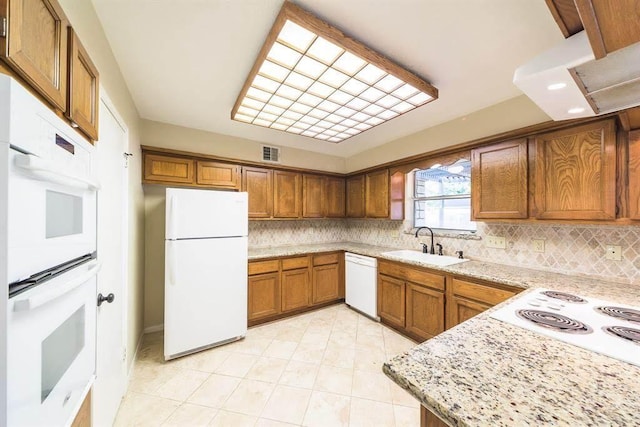 2707 Williams Grant St, Sugar Land, TX 77479 - kitchen with white appliances, a sink, brown cabinets, tasteful backsplash, and recessed lighting