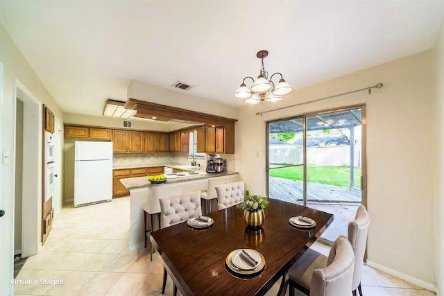 2707 Williams Grant St, Sugar Land, TX 77479 - dining space with a chandelier, light tile patterned floors, and baseboards