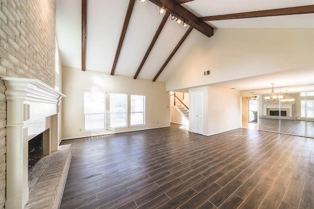 2707 Williams Grant St, Sugar Land, TX 77479 - unfurnished living room with a fireplace with raised hearth, high vaulted ceiling, beam ceiling, stairway, and plenty of natural light