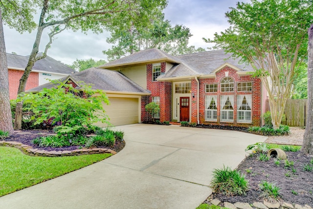 12911 Peach Meadow Dr, Cypress, TX 77429 - view of front of property featuring driveway, brick siding, an attached garage, a shingled roof, and fence