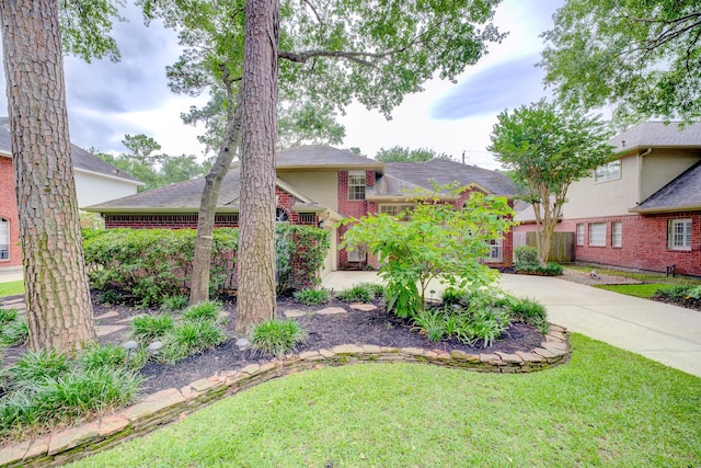 12911 Peach Meadow Dr, Cypress, TX 77429 - view of front of property with a front lawn, brick siding, and concrete driveway