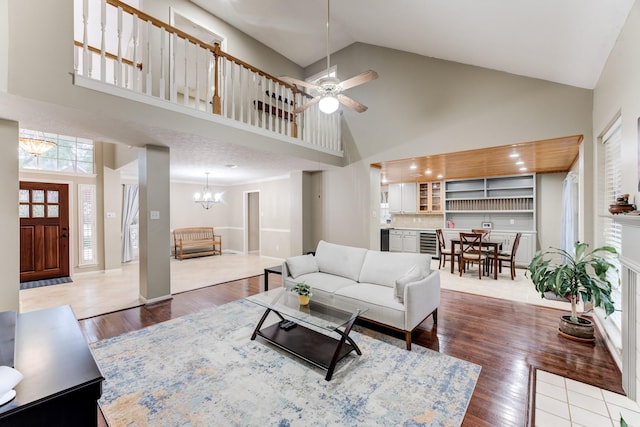 12911 Peach Meadow Dr, Cypress, TX 77429 - living area featuring high vaulted ceiling, a chandelier, wood finished floors, and ceiling fan