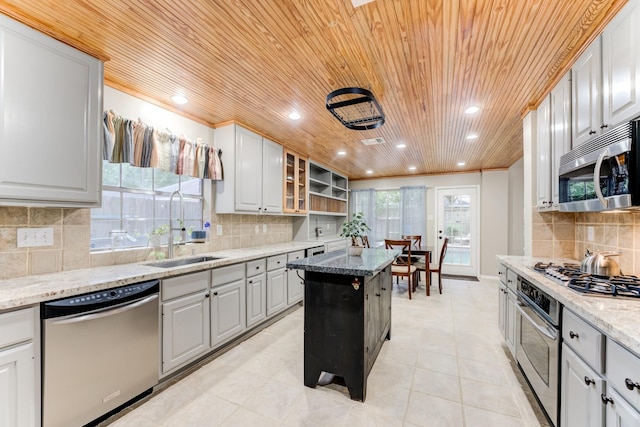 12911 Peach Meadow Dr, Cypress, TX 77429 - kitchen featuring appliances with stainless steel finishes, a sink, wood ceiling, open shelves, and decorative backsplash