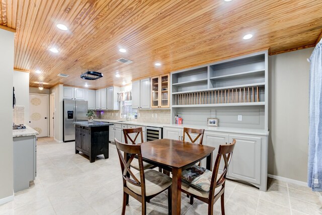 12911 Peach Meadow Dr, Cypress, TX 77429 - dining space featuring wood ceiling, wine cooler, baseboards, recessed lighting, and light tile patterned floors