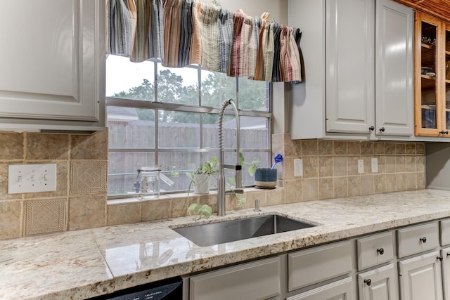 12911 Peach Meadow Dr, Cypress, TX 77429 - kitchen with a sink, glass insert cabinets, tasteful backsplash, and white cabinetry