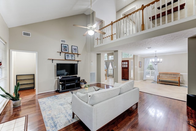 12911 Peach Meadow Dr, Cypress, TX 77429 - living area with wood finished floors, a chandelier, high vaulted ceiling, a ceiling fan, and baseboards