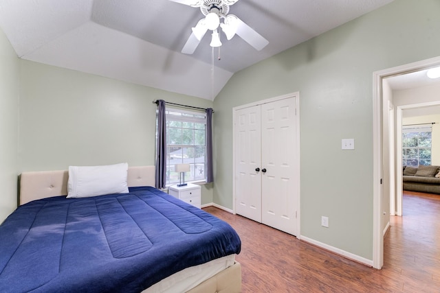 12911 Peach Meadow Dr, Cypress, TX 77429 - bedroom featuring wood finished floors, lofted ceiling, a closet, baseboards, and a ceiling fan
