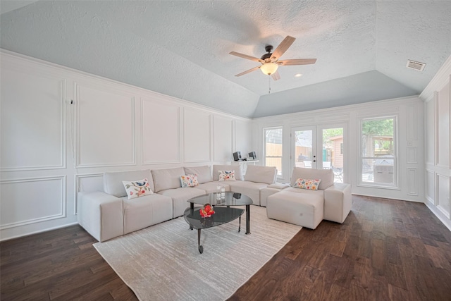 715 Cheltenham Dr, Katy, TX 77450 - living room with a decorative wall, lofted ceiling, dark wood-style flooring, a ceiling fan, and a textured ceiling