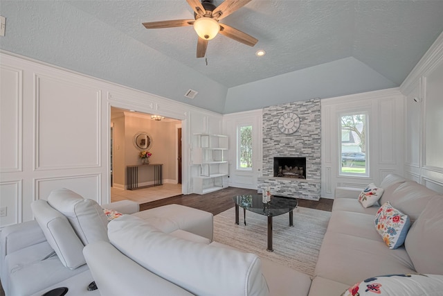 715 Cheltenham Dr, Katy, TX 77450 - living area with a textured ceiling, vaulted ceiling, wood finished floors, a ceiling fan, and a decorative wall