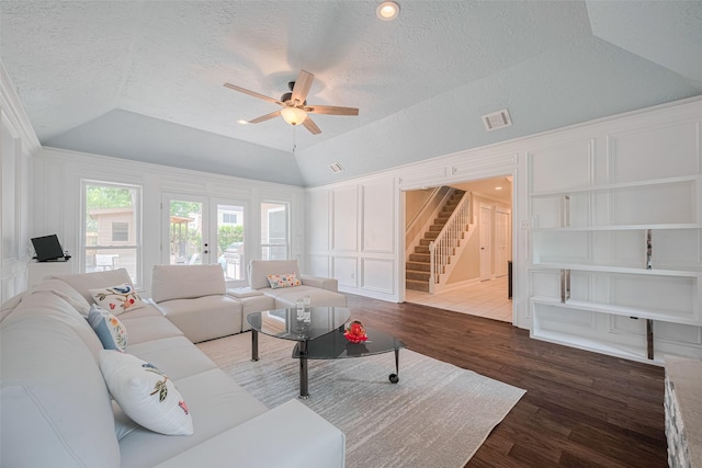 715 Cheltenham Dr, Katy, TX 77450 - living area with lofted ceiling, stairs, a ceiling fan, a decorative wall, and a textured ceiling