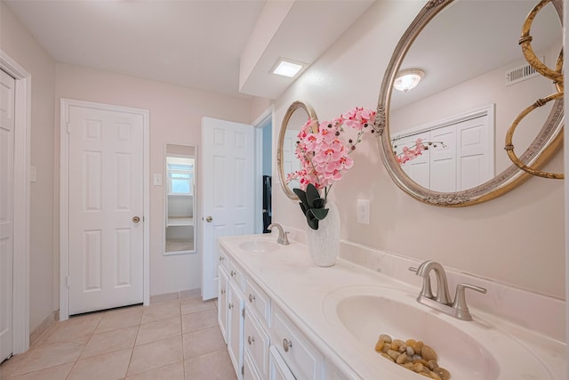 715 Cheltenham Dr, Katy, TX 77450 - full bathroom with tile patterned floors, double vanity, and baseboards