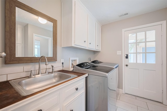715 Cheltenham Dr, Katy, TX 77450 - clothes washing area with separate washer and dryer, cabinet space, and light tile patterned floors