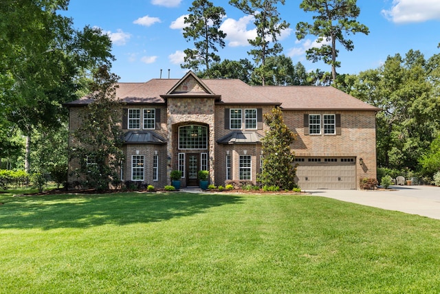 4810 Pine Wood Meadows Ln, Spring, TX 77386 - view of front of property with an attached garage, concrete driveway, a front lawn, and a standing seam roof