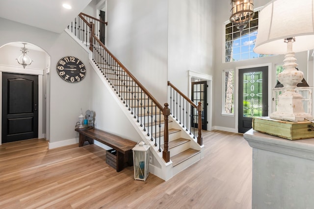 4810 Pine Wood Meadows Ln, Spring, TX 77386 - entryway with wood finished floors, a towering ceiling, arched walkways, and healthy amount of natural light