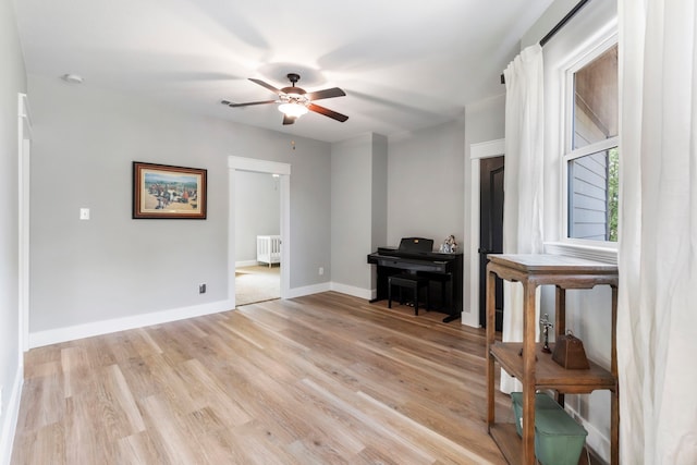 4810 Pine Wood Meadows Ln, Spring, TX 77386 - spare room featuring radiator, light wood-type flooring, a ceiling fan, and baseboards