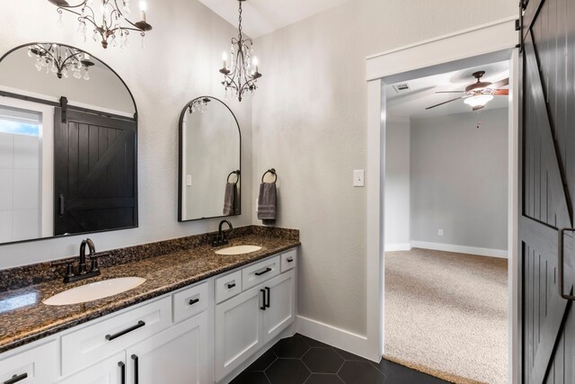 4810 Pine Wood Meadows Ln, Spring, TX 77386 - bathroom with double vanity, baseboards, a ceiling fan, and tile patterned floors