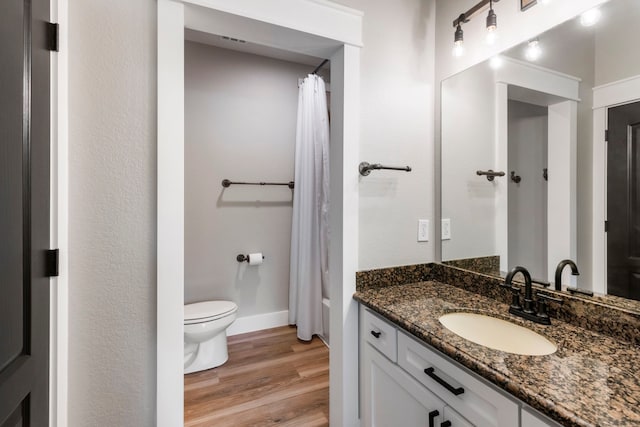 4810 Pine Wood Meadows Ln, Spring, TX 77386 - bathroom featuring vanity, toilet, wood finished floors, and baseboards