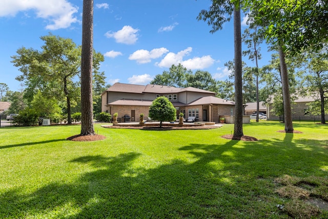4810 Pine Wood Meadows Ln, Spring, TX 77386 - view of grassy yard featuring a patio area