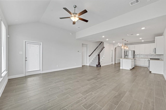 11826 Tranquility Summit Dr, Cypress, TX 77433 - unfurnished living room featuring stairs, ceiling fan, light wood-style floors, lofted ceiling, and recessed lighting