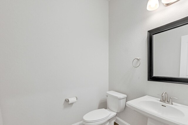 11826 Tranquility Summit Dr, Cypress, TX 77433 - half bathroom with baseboards, toilet, and a sink