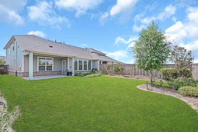11826 Tranquility Summit Dr, Cypress, TX 77433 - back of house featuring a patio area, stone siding, and a shingled roof