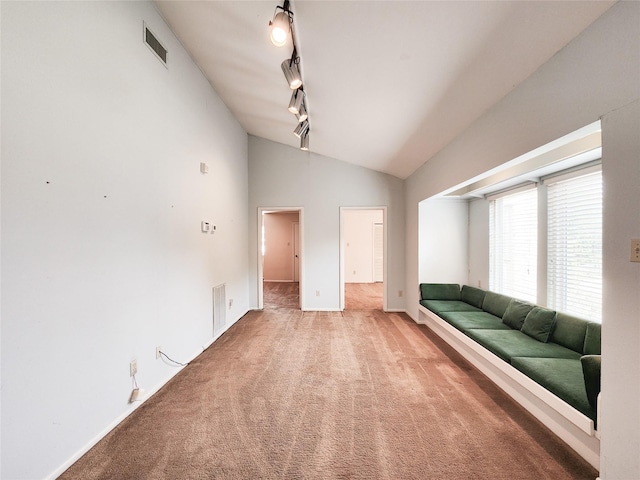 7910 Woodway Dr, Houston, TX 77063 - unfurnished living room with lofted ceiling, light carpet, and rail lighting