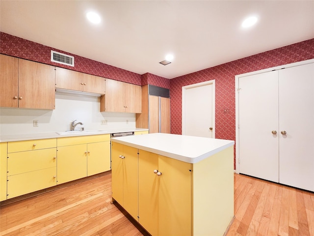 7910 Woodway Dr, Houston, TX 77063 - kitchen with a sink, wallpapered walls, light wood-type flooring, and light countertops