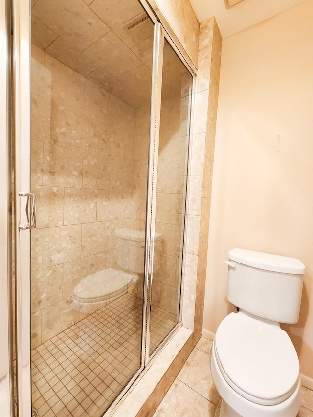 7910 Woodway Dr, Houston, TX 77063 - bathroom featuring toilet, a stall shower, tile patterned flooring, and baseboards
