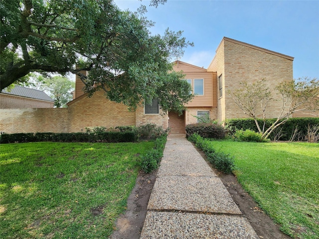 7910 Woodway Dr, Houston, TX 77063 - view of front facade featuring a front lawn and brick siding