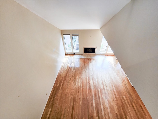 7910 Woodway Dr, Houston, TX 77063 - unfurnished living room with wood finished floors, a fireplace, and baseboards