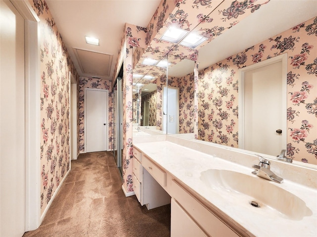 7910 Woodway Dr, Houston, TX 77063 - bathroom featuring wallpapered walls and vanity