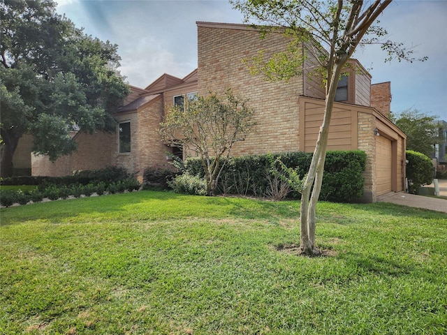 7910 Woodway Dr, Houston, TX 77063 - view of side of property with a lawn, an attached garage, and brick siding