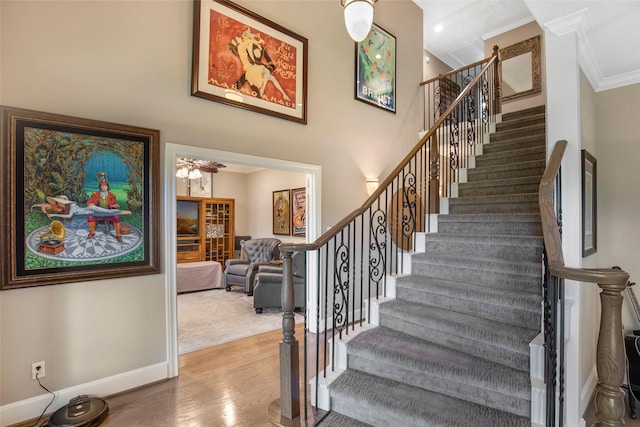 3315 E Bayou Dr, Shoreacres, TX 77571 - staircase featuring ornamental molding and wood finished floors