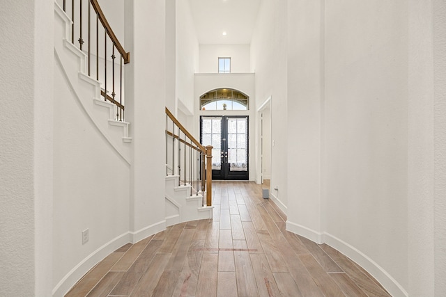 28946 Parker Ridge Dr, Katy, TX 77494 - foyer entrance featuring stairs, hardwood / wood-style floors, baseboards, a towering ceiling, and french doors