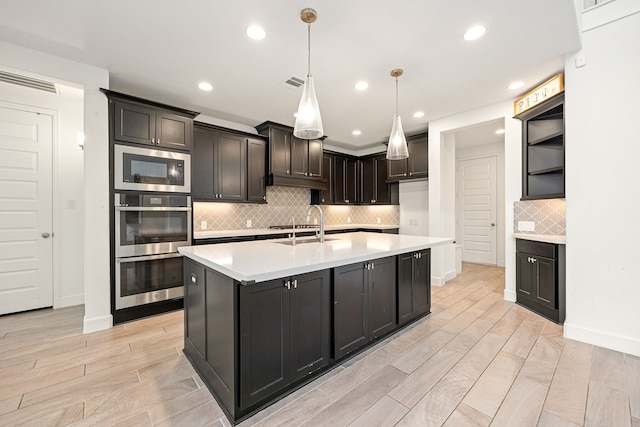 28946 Parker Ridge Dr, Katy, TX 77494 - kitchen featuring appliances with stainless steel finishes, light countertops, backsplash, light wood-style flooring, and recessed lighting