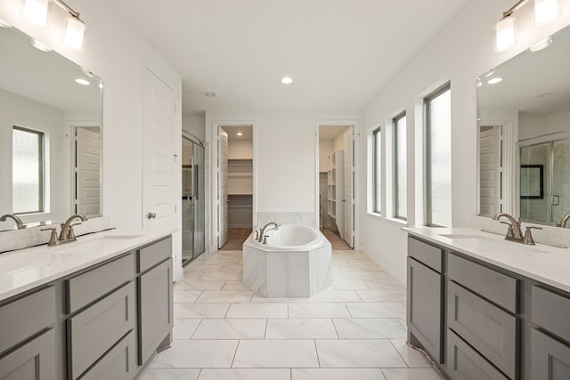 28946 Parker Ridge Dr, Katy, TX 77494 - full bathroom with a shower stall, a garden tub, two vanities, a walk in closet, and recessed lighting