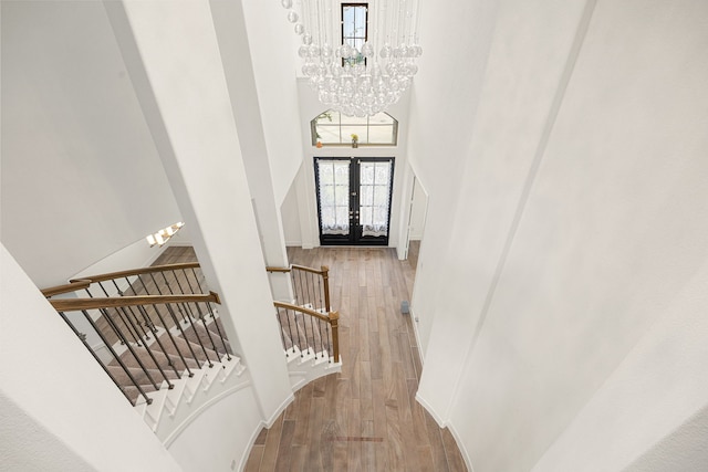 28946 Parker Ridge Dr, Katy, TX 77494 - stairway with a towering ceiling, a chandelier, wood finished floors, and french doors